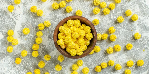 top-view-yellow-little-candies-white-surface-color-many-granule-candy